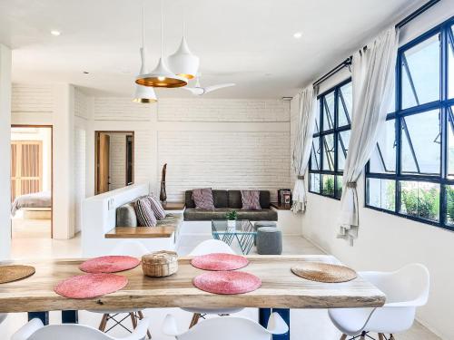a living room with a table and some chairs at Punta Mita Surf Lodge in Punta Mita
