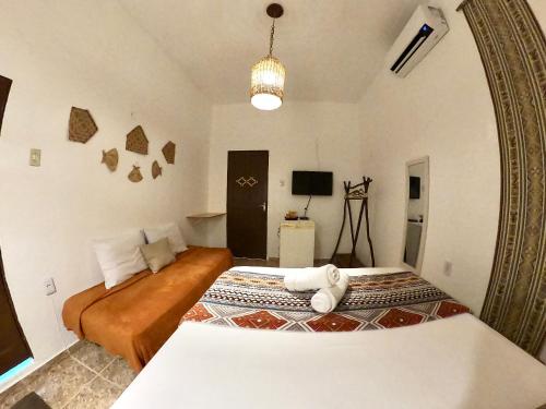 a bedroom with a bed and a large mirror at Pousada Ocazum in Alter do Chao