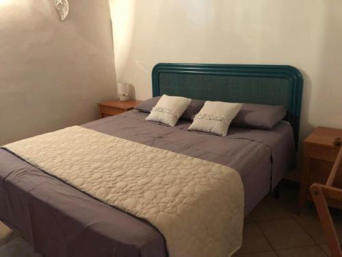 a bedroom with a large bed with two pillows at Casa nel borgo in Piglio