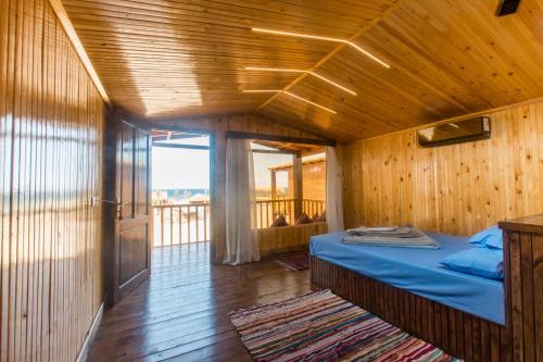 a bedroom with a bed in a wooden room at Paradise Sweir in Nuweiba