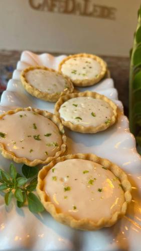 four pies on a plate on a table at Pousada da Leide in Fernando de Noronha