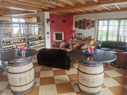 a wine tasting room with two tables and chairs at Hôtel Au Feu De Bois in Autrans
