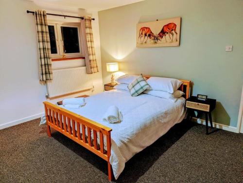 a bedroom with a large bed and a window at Country Lodge Retreat in Lydney