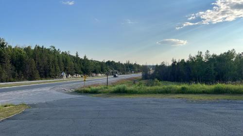 an empty road with trees on the side of the road at Lively Inn and Suites - Sudbury in Naughton