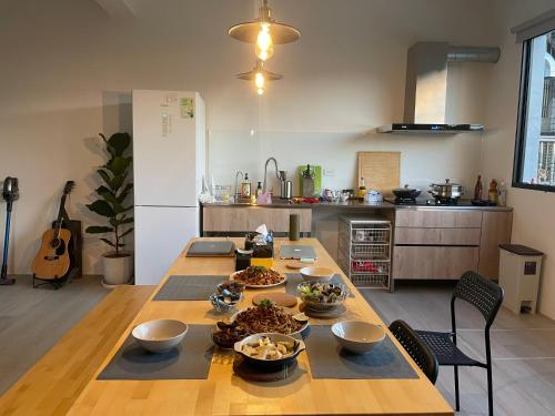 a kitchen with a table with bowls of food on it at Tino House 全新開幕 質感包棟民宿 in Yilan City