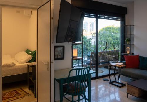 a small apartment with a bedroom and a balcony at Lovely 1-bedroom apartment in The best location in Tel Aviv