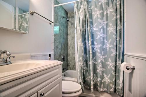 a bathroom with a shower with a toilet and a sink at 1 Mi to Beach Home with Deck and BBQ in East Falmouth in East Falmouth