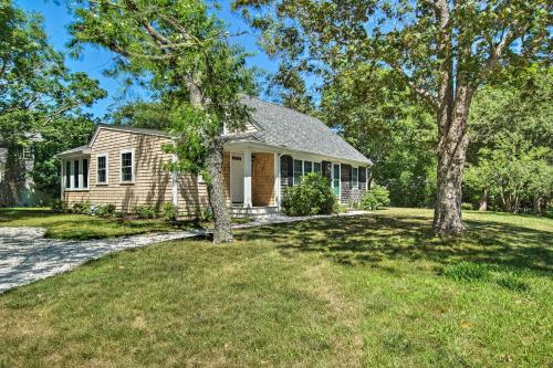 a house with trees in front of a yard at 1 Mi to Beach Home with Deck and BBQ in East Falmouth in East Falmouth