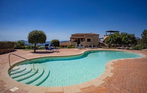 a large swimming pool with chairs and a house at Residenza Grazia sul mare in Abbiadori