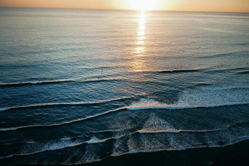 an aerial view of the ocean at sunset at Hidden Palms in Nosara