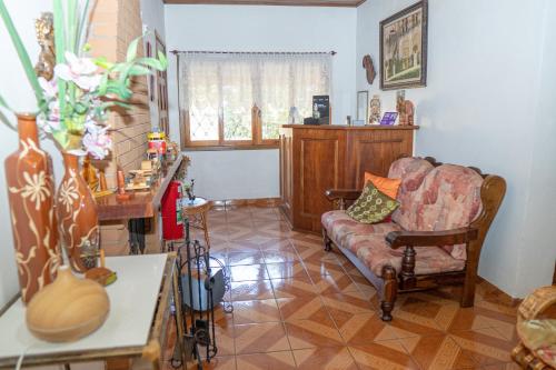 a living room with a couch and a table at pousada helebastian in Campos do Jordão