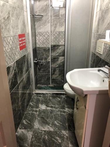 a bathroom with a shower and a toilet and a sink at Istanbul Hotel&Guesthouse in Istanbul