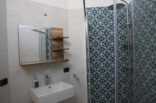 a bathroom with a shower and a sink and a mirror at La Neviera in Struda