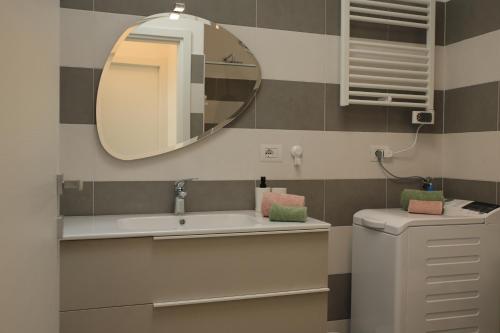 a bathroom with a sink and a mirror at Magnolia Lake Como city center Free Parking in Como