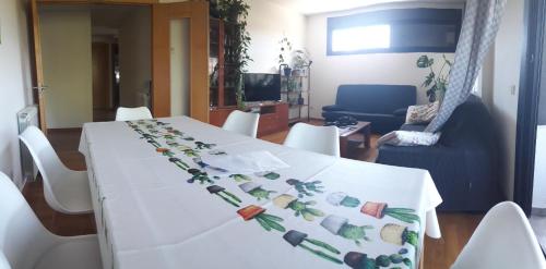 a table with a white table cloth with vegetables on it at El Descanso in Aínsa