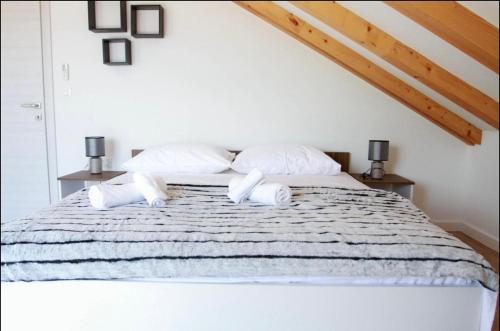a bedroom with a bed with two pillows on it at Villa BO in Koprivno