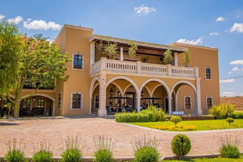 a large house with a courtyard in front of it at HC HACIENDA CATRINA HOTEL BOUTIQUE in Silao