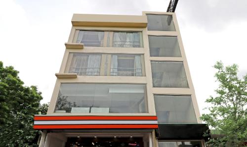 a tall white building with glass windows at Treebo Trend Galaxy Rooms in New Delhi