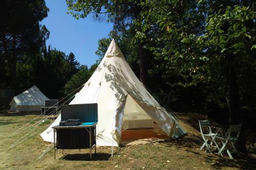 a tent with a tv and a desk in it at Toscana Holiday Village in Montopoli in Val dʼArno