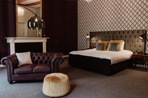 a bedroom with a bed and a couch and a chair at Châteauhotel De Havixhorst in Schiphorst