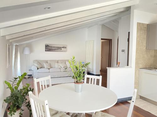 biała jadalnia z białym stołem i krzesłami w obiekcie Casa Alda w mieście La Spezia