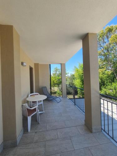 a balcony with a table and chairs and a view at Albergo Campagnola in Lazise