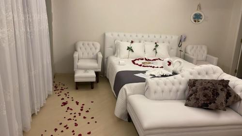 a bedroom with a bed with red petals on the floor at Paraíso do Salto in Lages