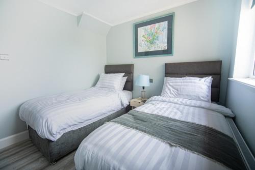 two twin beds in a room with at Half Door House in Dingle