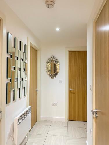 a hallway with a door and a wreath on the wall at Wharf Inn Premier Apartment Central Manchester - Free Private Parking in Manchester