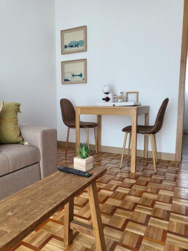 a living room with a table and a couch at Villa Ria in Ovar