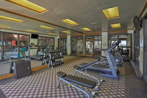 a gym with several treadmills and elliptical machines at Mountain Getaway and Pool at Brian Head Ski Resort in Brian Head