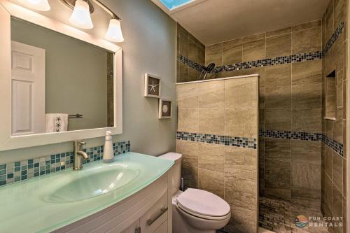 a bathroom with a sink and a toilet and a shower at Beachside Getaway with Private Fenced Yard & Fire Pit STEPS from Flagler Avenue! in New Smyrna Beach