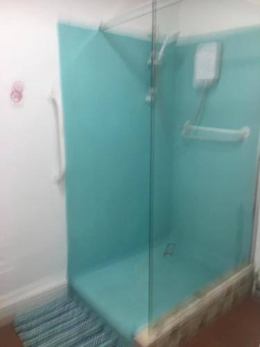 a shower with a glass door in a bathroom at SINGER HOUSE ,PAIGNTON SEAFRONT ,SLEEPS 6 , 2 BEDROOM GROUND FLOOR SELF CONTAINED GARDEN FLAT , PRIVATE ENTRANCE , KITCHEN , Guaranteed Parking ,Wifi , Movies ,Bathroom ,fridge , microwave ,BEDROOM 1, DOUBLE BED & 2 SINGLE BEDS ,BEDROOM 2 , DOUBLE BED in Paignton