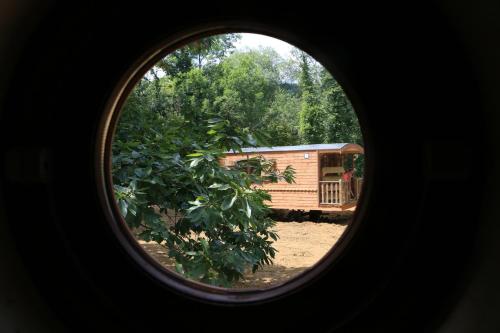 a view of a train through a round window at Les roulottes a Sandie in Thionville