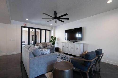 a living room with a couch and a flat screen tv at The Latitude Adjustment, located close to Golf,Sand Dunes, Reservoir & National Parks in Hurricane