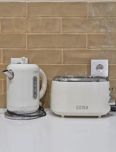 a toaster and a toaster sitting on a counter at Flats 323 apartments in Porto