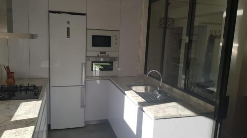 a kitchen with a sink and a refrigerator at Apartamento Vadillos - VuT 09-401 in Burgos