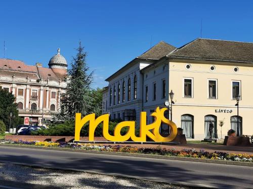 a large maks sign in the middle of a street at Valentin Apartman in Makó