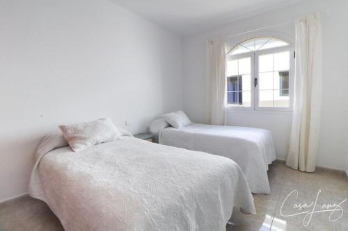a bedroom with two beds and a window at Cliff View Orzola in Órzola