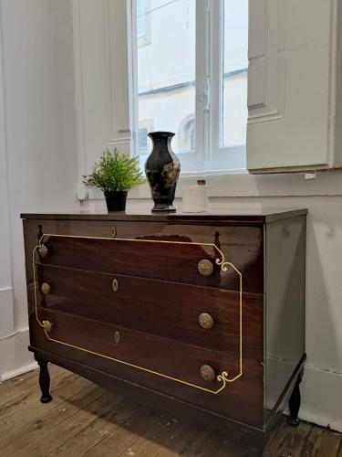 a dresser with a vase sitting on top of it at Party Zone in Lisbon