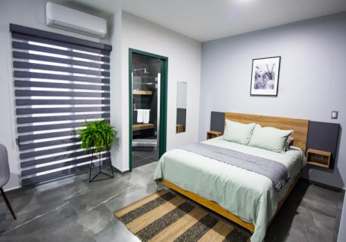 a bedroom with a large bed and a window at Nidah Condominios in Durango