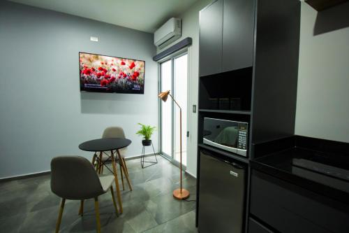 a kitchen with a table and chairs in a room at Nidah Condominios in Durango