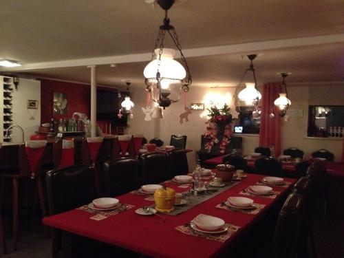 a dining room with a long table with red table cloth at fun4all-holidayhome in Medebach