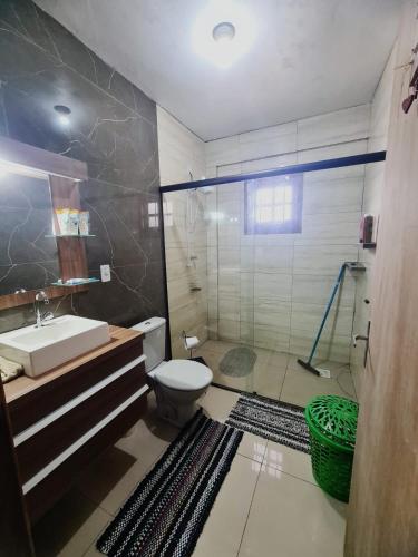 a bathroom with a toilet and a sink and a shower at MARE 3 - DE PEDRA - natureza in Torres