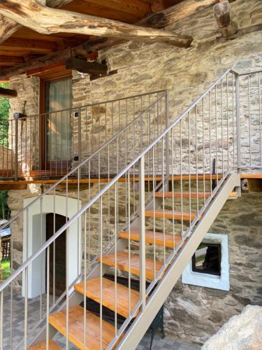 a metal staircase in a stone house at La Fnera in Cavaliggi