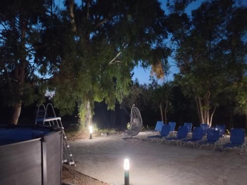 a group of chairs and a playground with a candle at Marti Garden Suites in Skala Prinou