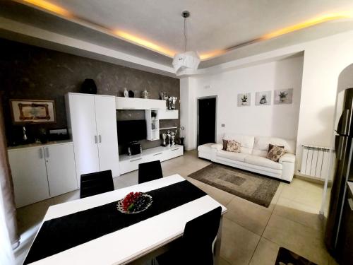 a living room with a table and a couch at Campi Elisi in Siracusa