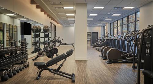 a gym with rows of treadmills and weights at Pendry Park City in Park City