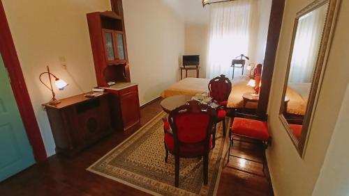 a room with a bedroom with a bed and a table at Atheaton Traditional Guest Ηouse Nafplion in Nafplio