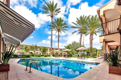 a pool at a resort with palm trees at Sleep Inn Monterrey Norte in Monterrey